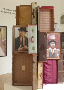A stack of  suitcases featuring photographic portraiture from the 'Return of the Rudeboy' exhibition.