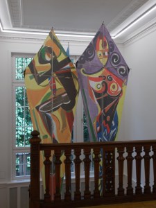 Kites painted by El Hadji Sy in 1994, positioned above the staircase at the Weltkulturen Museum.