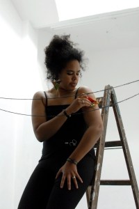 A still from the performance installation "Planting Present Tense" by Nathalie Mba Bikoro (Berlin, 2015). Source: http://www.nbikoro.com. 