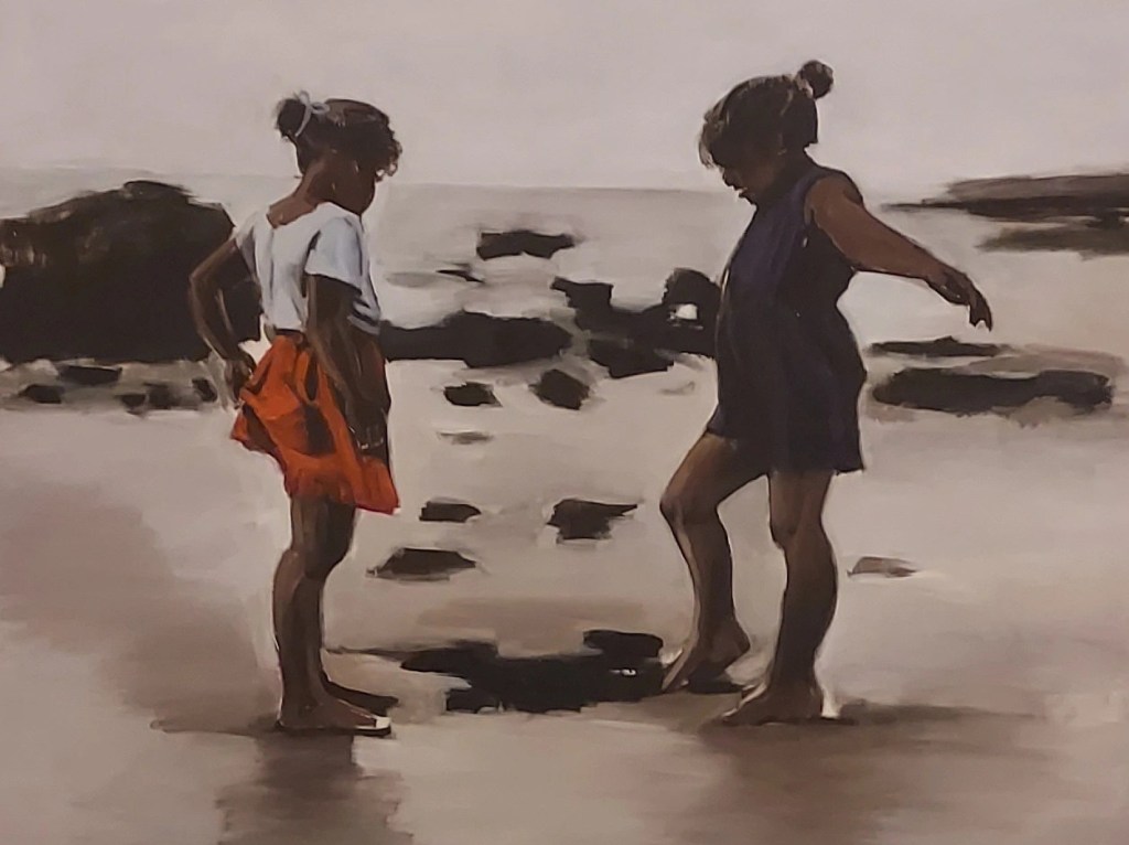 Oil painting showing two young girls playing on the beach, looking down at the sand, with the child on the right dipping her right foot into a puddle of of water.