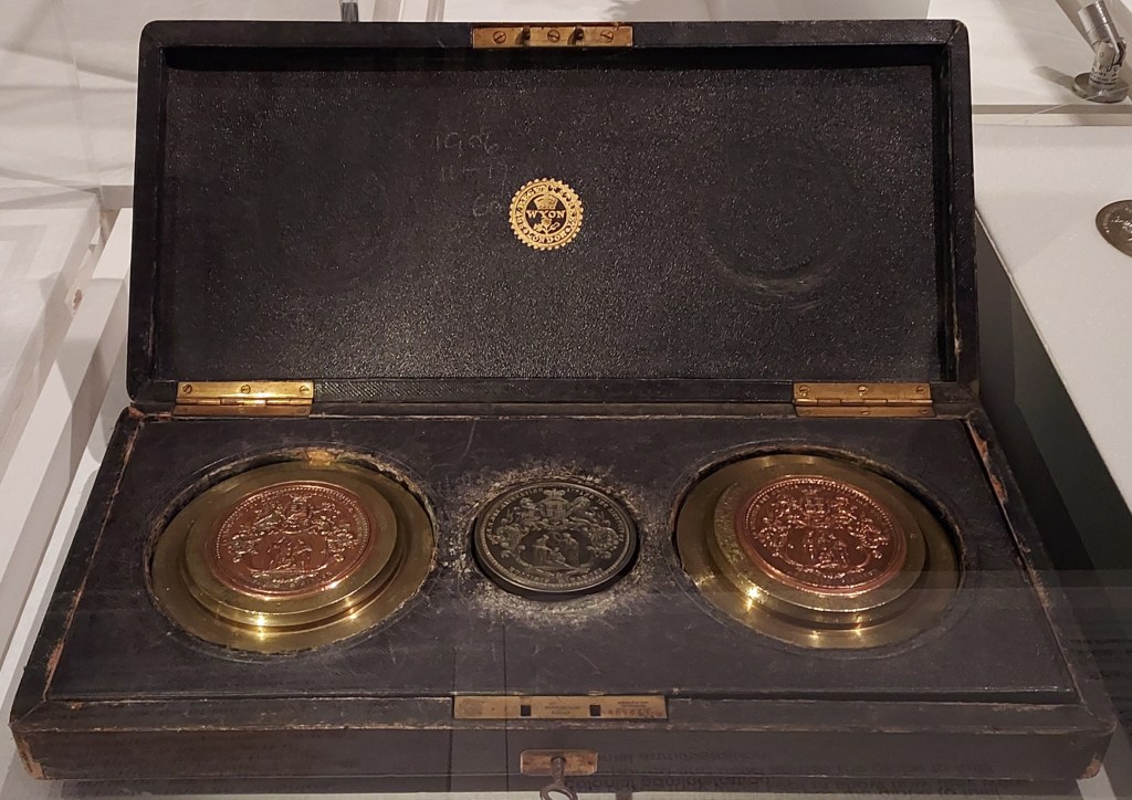 Two Sovereign seals presented in a display case.