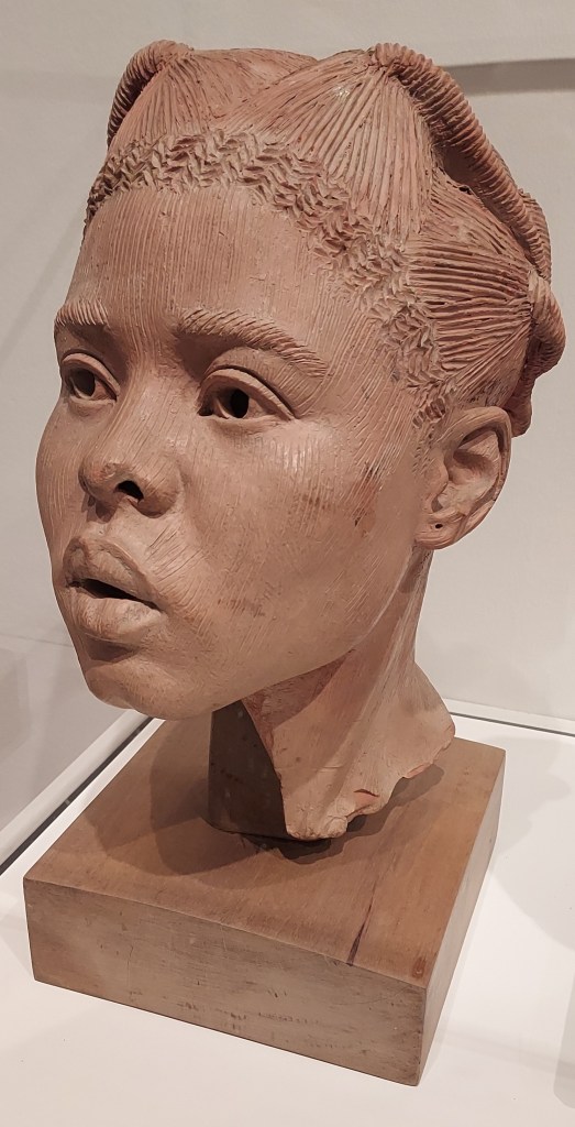 Terracotta sculpture depicting the head of a young Nigerian woman.